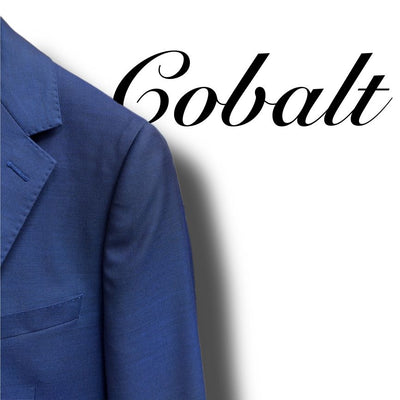 Close-up of the left shoulder and lapel of the Paul Betenly Solid Suit - Slim Fit in cobalt blue, with "Cobalt" in cursive on a white background—a stylish Paul Betenly option for modern men's suits.