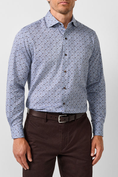 A man wearing the David Donahue Floral Sport Shirt CMSW13400—a light blue men’s floral print shirt in soft cotton sateen by David Donahue—paired with brown pants and a matching brown belt, standing against a plain background.