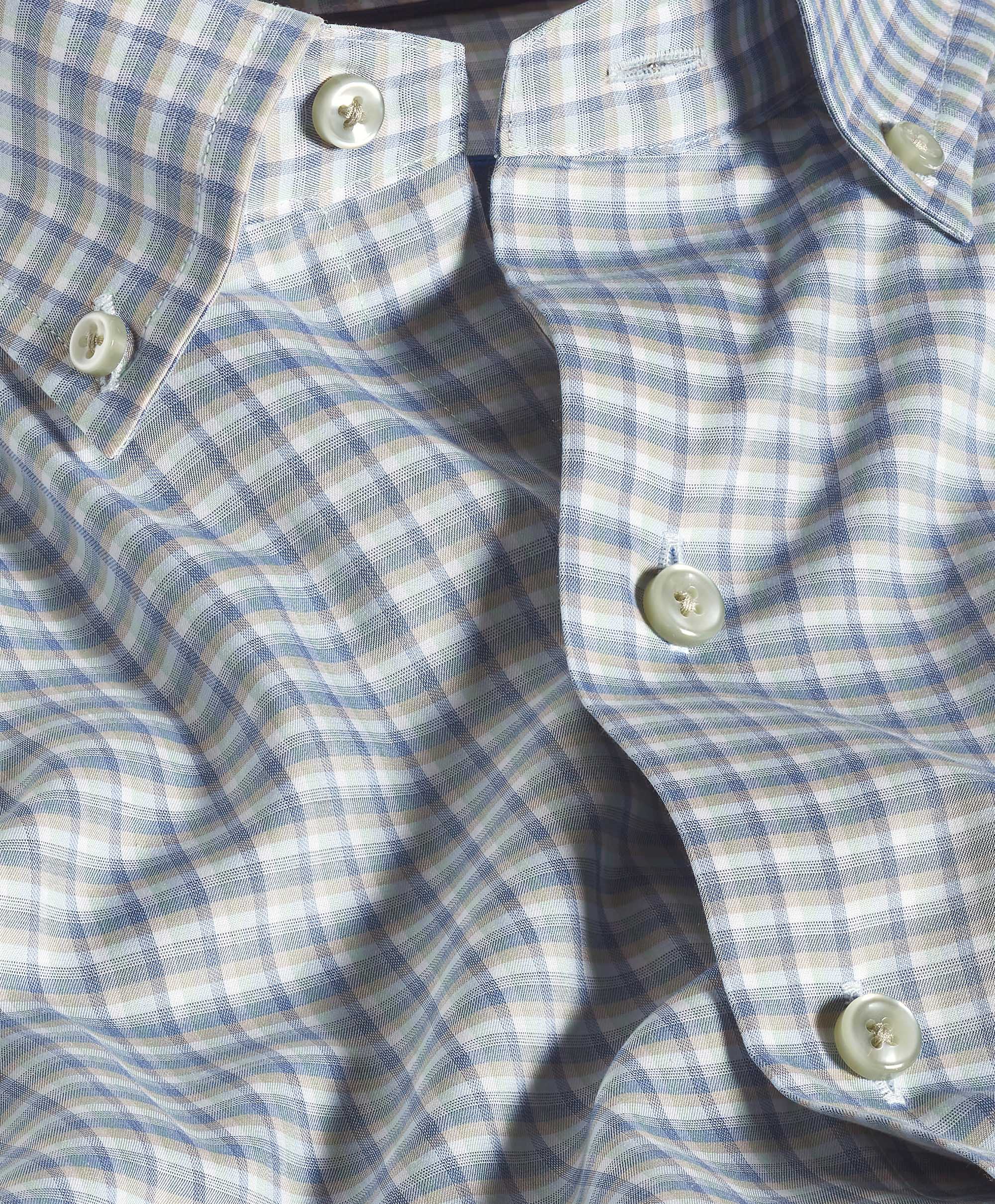 Close-up of a blue and white checkered shirt with buttons.