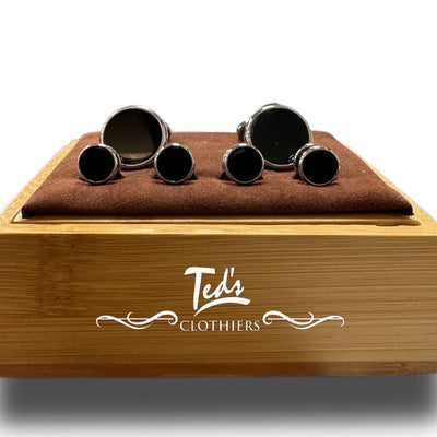 Six pairs of round, black cufflinks from the Bocara Stud & Cufflinks Set by Bocara are displayed on a brown velvet pad atop a wooden box—a timeless formal accessory for any occasion.