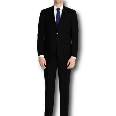 A man in a Hart Schaffner Marx Chicago Fit Suit Big & Tall with a white shirt and blue tie stands against a white background, highlighting refined men’s luxury workwear from Hart Schaffner Marx.