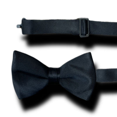 The IKE Pre-Tied Silk Bow Tie by Ike Behar is a black silk accessory with an adjustable strap and metal clasp, laid flat on a white background—perfect for any formal occasion.