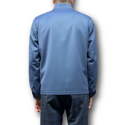 A person is pictured from behind wearing the Mattarazi Coat Paolo by Mattarazi in blue, paired with dark plaid pants, set against a plain white background.