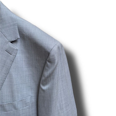 Close-up of the upper left side of the Paul Betenly Solid Suit - Slim Fit jacket, featuring a notch lapel and chest pocket from Paul Betenly, set against a white background.