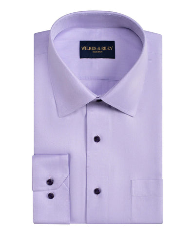The Wilkes & Riley Herringbone Dress Shirt, in light purple Supima cotton with a pointed collar and buttoned cuffs, features a wrinkle-free, non-iron finish and displays the Wilkes & Riley label inside the collar.