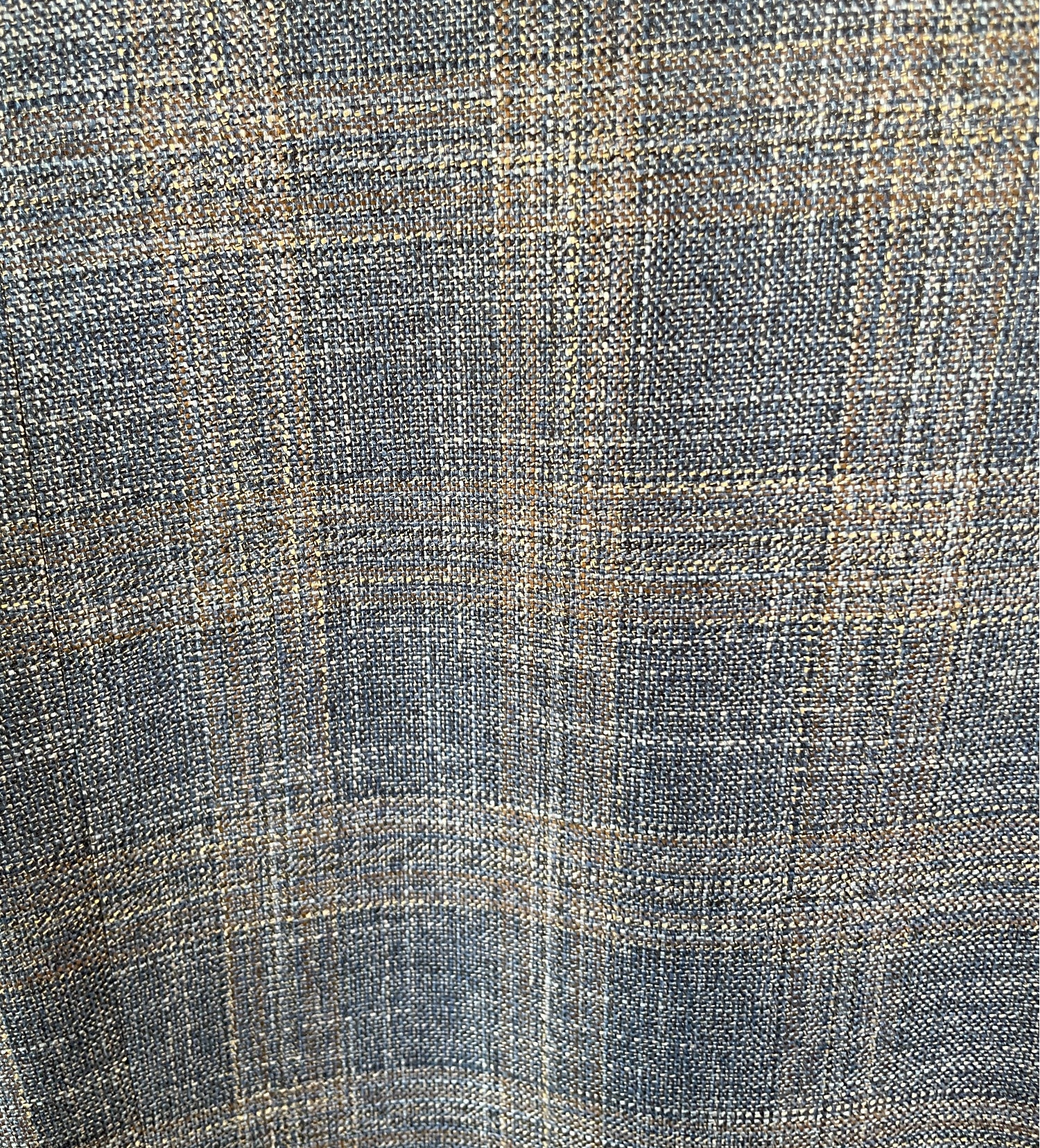 Close-up of a textured fabric with a checkered pattern in shades of blue and beige.