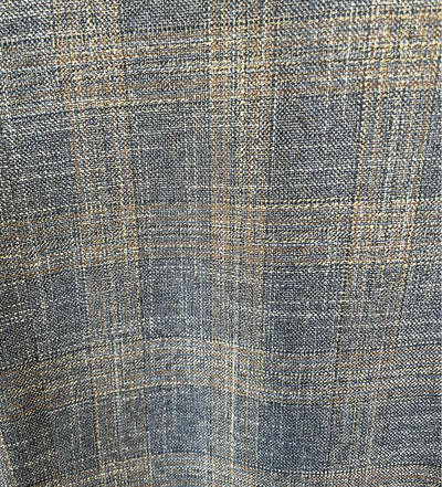 Close-up of a textured fabric with a checkered pattern in shades of blue and beige.