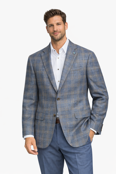 Man wearing a blue plaid suit jacket and pants on a white background