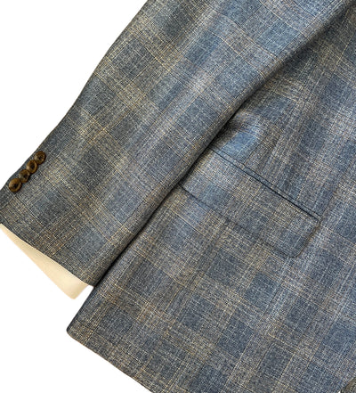 Close-up of a blue checkered fabric with a button on a white background