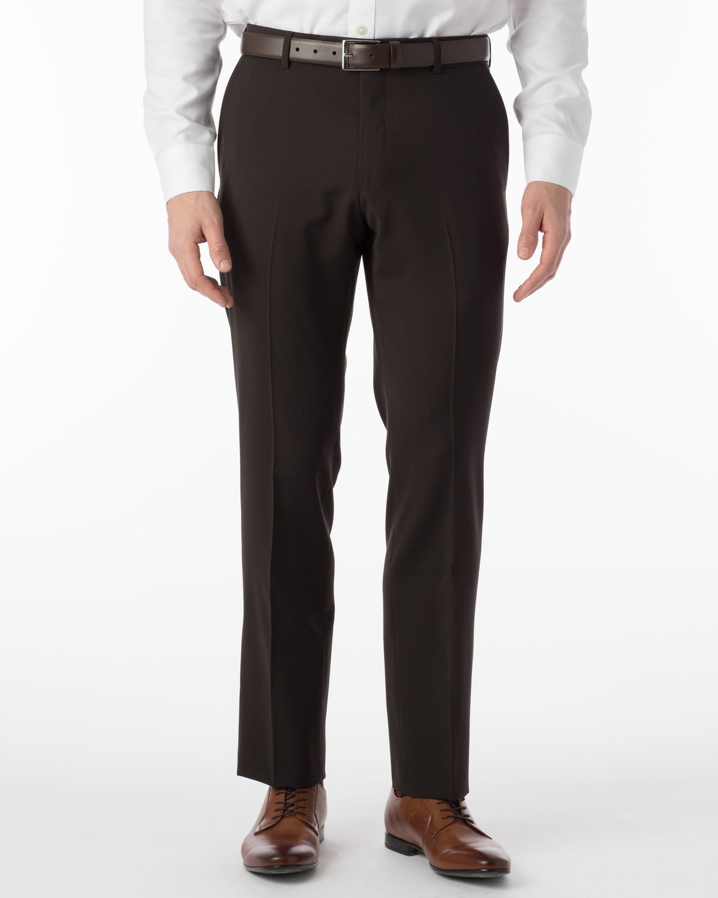 A person wearing Ballin Comfort-EZE Dress Pants in brown (Soho Modern Fit) from Ted's Clothiers, paired with a white dress shirt, black belt, and brown dress shoes, stands against a plain white background.