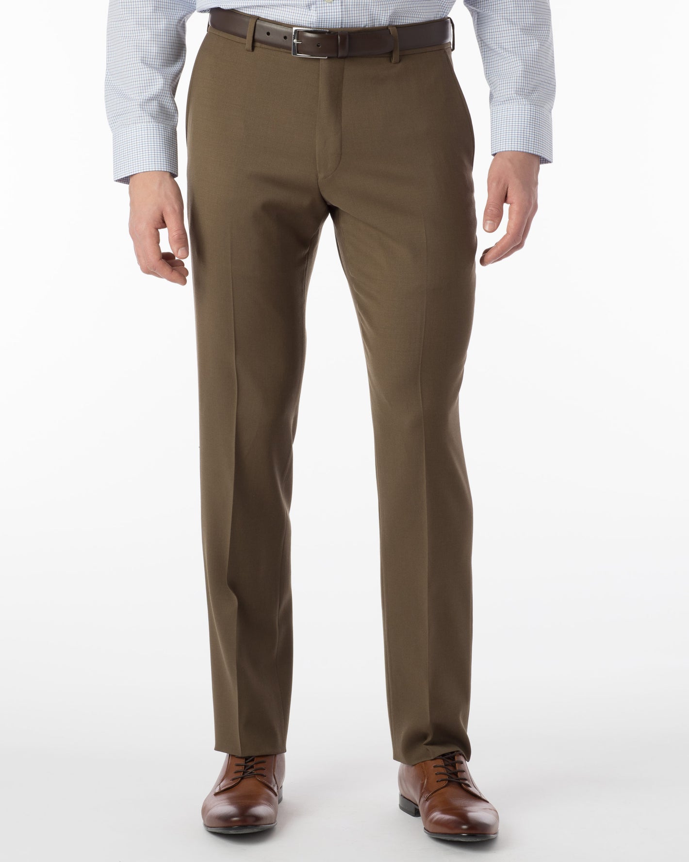 A person wearing Ted's Clothiers Ballin Comfort-EZE Dress Pants - Saddle- Soho Modern Fit stands against a plain white background, paired with a light blue checkered shirt, brown leather belt, and brown dress shoes.