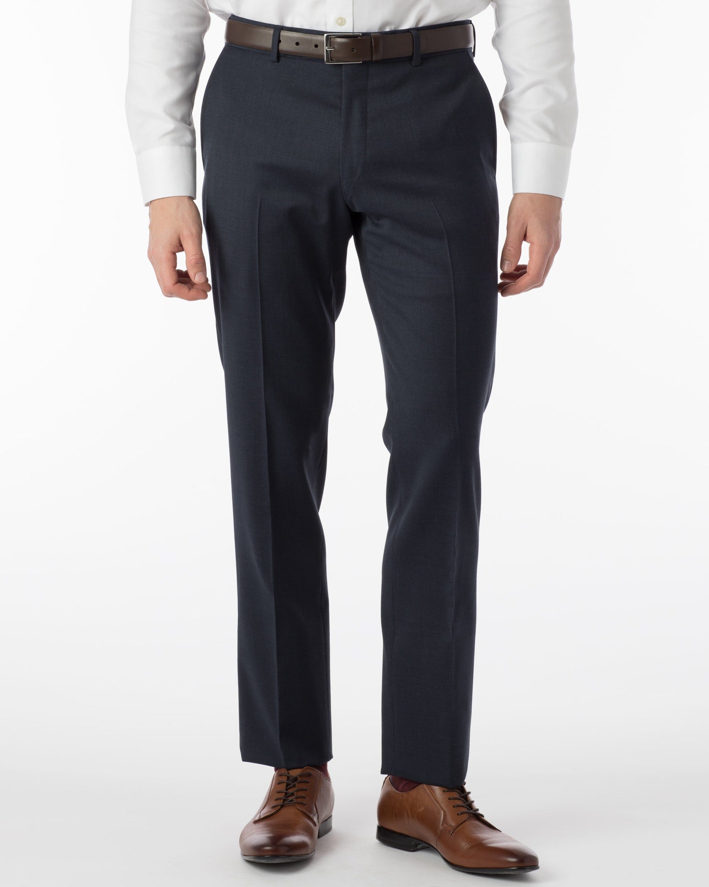 A person wearing Ted's Clothiers Ballin Comfort-EZE Dress Pants - Navy Mix (Soho Modern Fit) with a white shirt, brown belt, and brown dress shoes, standing against a plain white background.