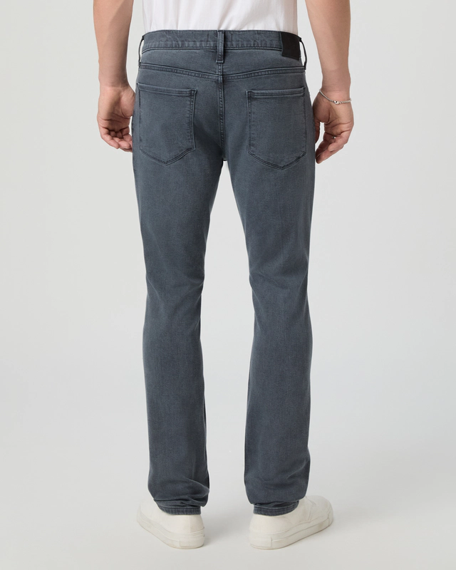 Person wearing blue jeans on a white background