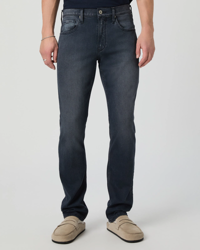 Person wearing dark blue jeans on a white background