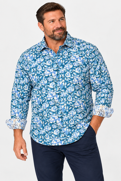 Man wearing the Robert Graham Euclid Long Sleeve Shirt Big & Tall in blue and white floral pattern, paired with navy pants, against a plain background.