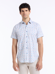 Man wearing a short-sleeve shirt with a light blue floral pattern on a white background