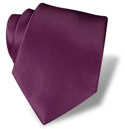 The DION Solid Silk Tie by Dion, in a rich dark purple, is artfully coiled against a white background—an ideal accessory for formal wear in Toronto.