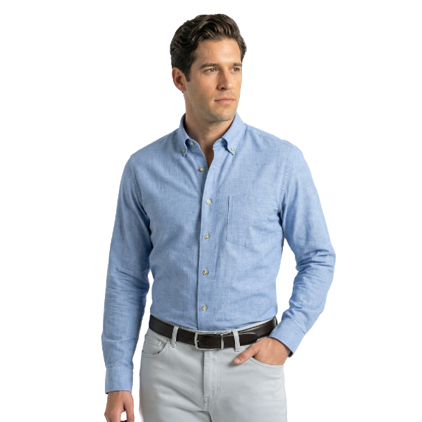 Man wearing a light blue button-up shirt and gray pants on a white background