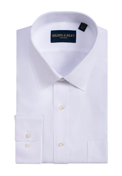 A neatly folded white Wilkes & Riley Solid Spread Collar Dress Shirt, Classic Fit, features a spread collar and buttoned cuffs, with the brand name on the inside of the collar.