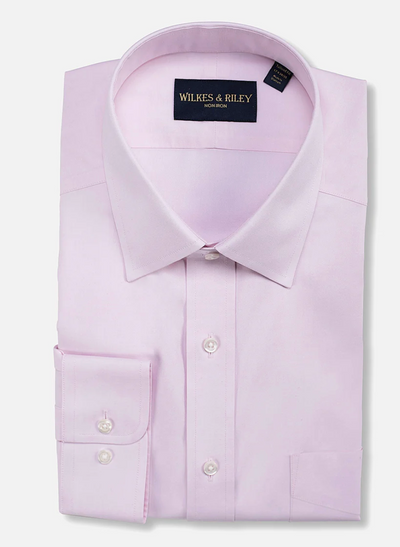 The Wilkes & Riley Solid Spread Collar Dress Shirt Classic Fit in light pink offers premium, wrinkle-free Supima cotton comfort with a spread collar and buttoned cuffs, featuring the signature Wilkes & Riley label inside the collar.