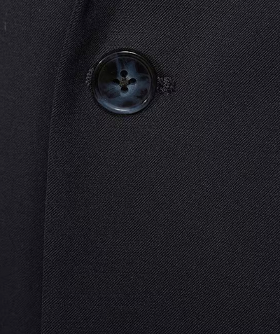 Close-up of dark fabric with a single black button, highlighting the refined details of the Hart Schaffner Marx Chicago Fit Suit Big & Tall by Hart Schaffner Marx.