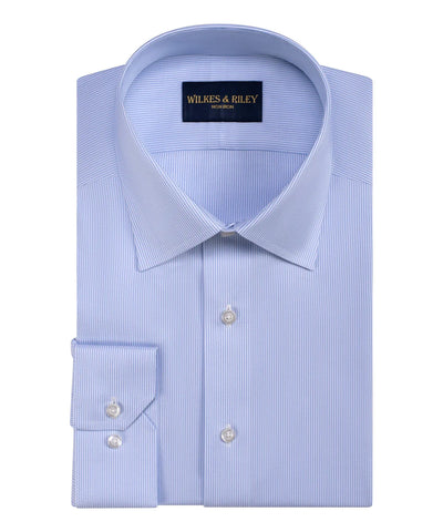A neatly folded Wilkes & Riley Twill Stripe Dress Shirt in light blue Supima cotton, featuring a pointed collar and buttoned cuffs, with the Wilkes & Riley label on the inner collar.