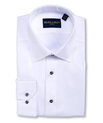 A neatly folded Wilkes & Riley Herringbone Dress Shirt for Big & Tall, white with a spread collar and black buttons, displays the Wilkes & Riley label inside the collar.