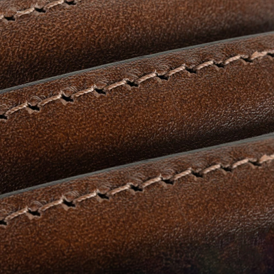 Close-up of brown Italian calfskin leather with visible stitching and texture, featured on the Allen Edmonds Wide Basic Belt, handcrafted in America.