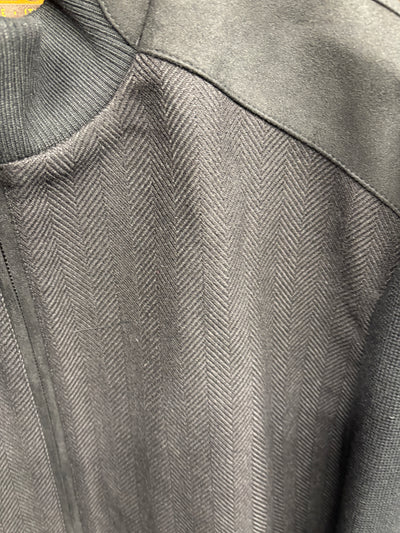 Close-up of the Enzo Nino Suede Bomber Jacket by Enzo, highlighting its dark-colored herringbone design with contrasting suede fabric on the shoulders and collar.