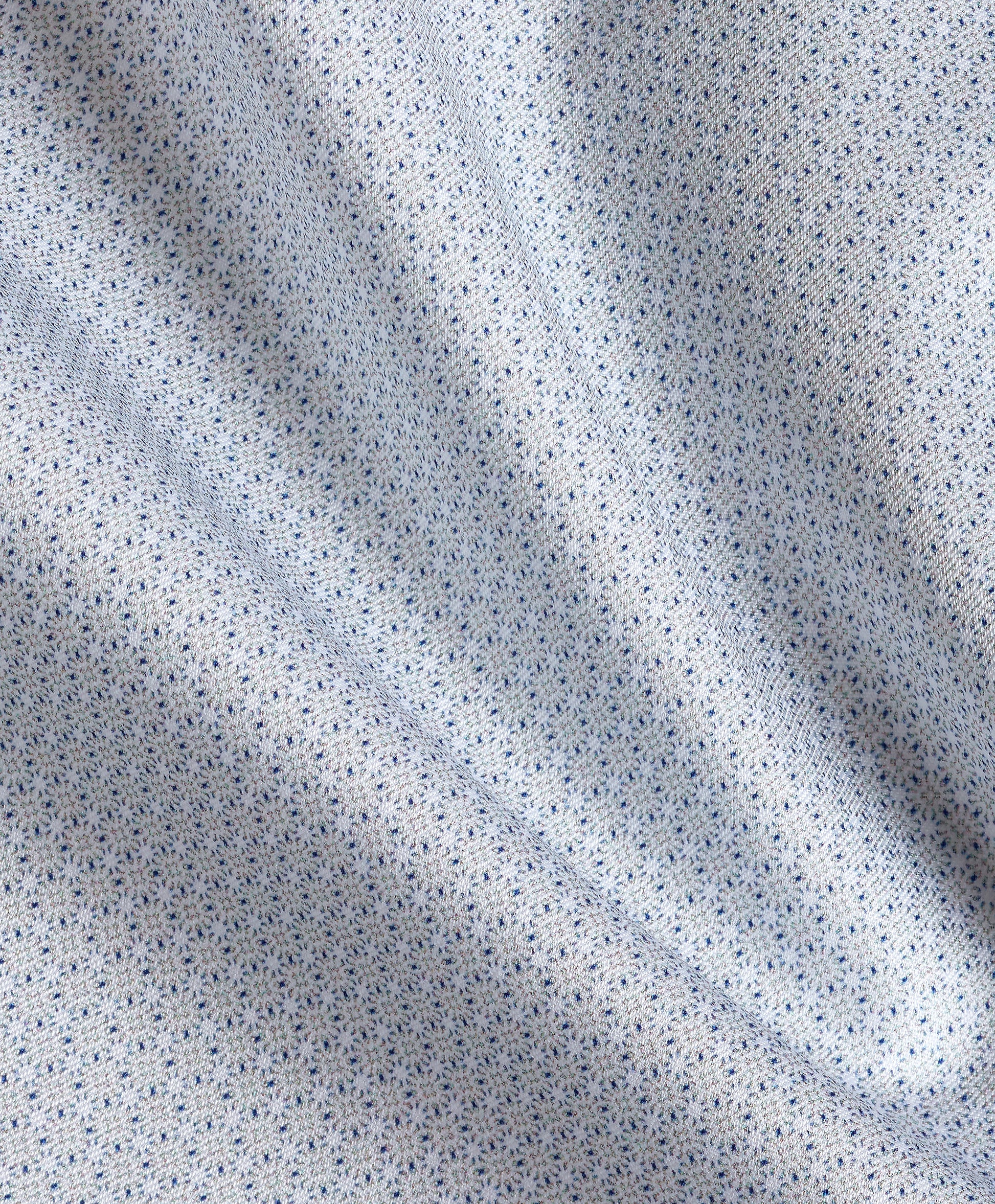 Close-up of light blue fabric featuring a small, repeating geometric print and visible folds, creating gentle shadows across the surface—reminiscent of the refined texture found in the David Donahue Micro Geometric Print Dress Shirt TBSP13203 by David Donahue.