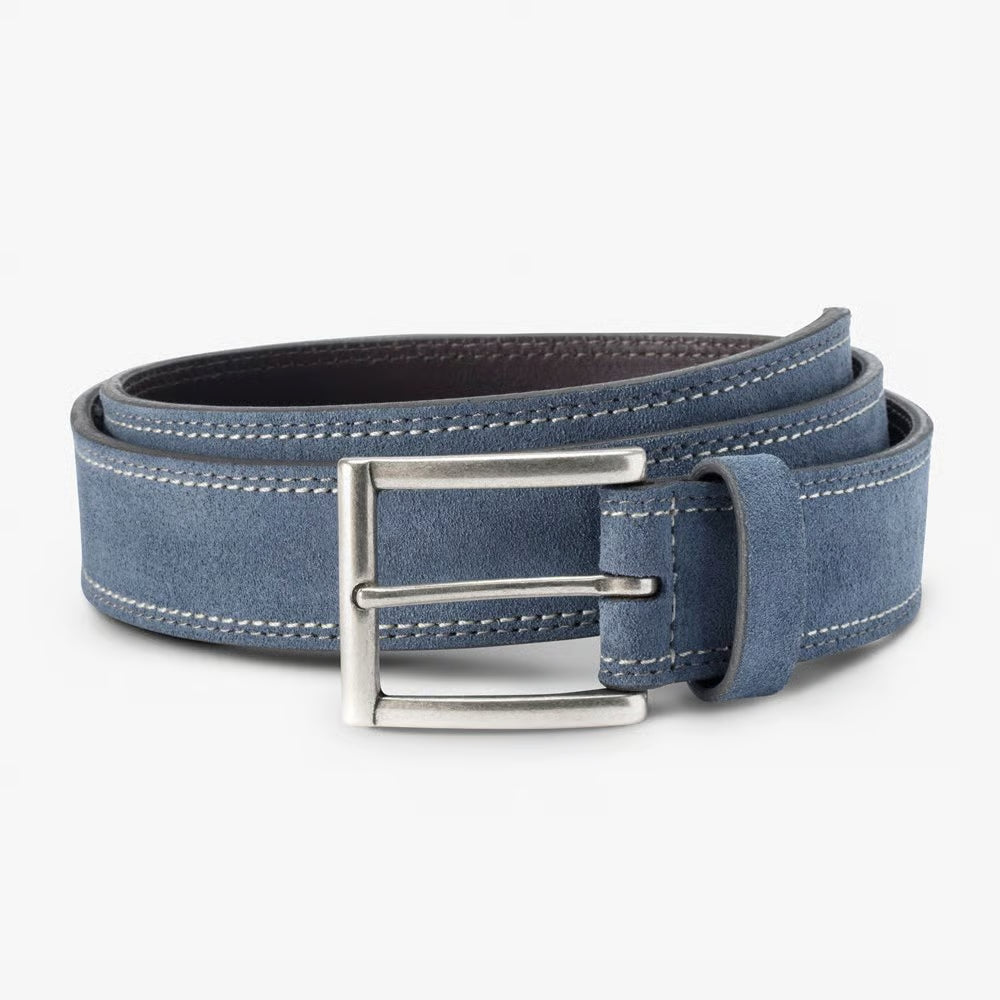The Allen Edmonds Bourbon Street Suede Belt by Allen Edmonds is a rolled-up blue European suede dress belt featuring white stitching and a silver rectangular buckle, handcrafted in America and displayed against a plain light background.