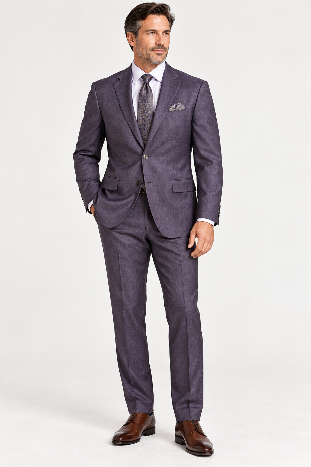 A man wearing a Jack Victor Napoli Suit Plum 3262603, a white dress shirt, a patterned tie, and dark brown leather dress shoes.