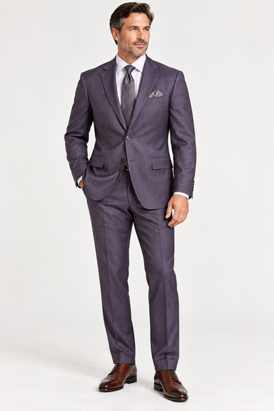 A man wearing a Jack Victor Napoli Suit Plum 3262603, a white dress shirt, a patterned tie, and dark brown leather dress shoes.