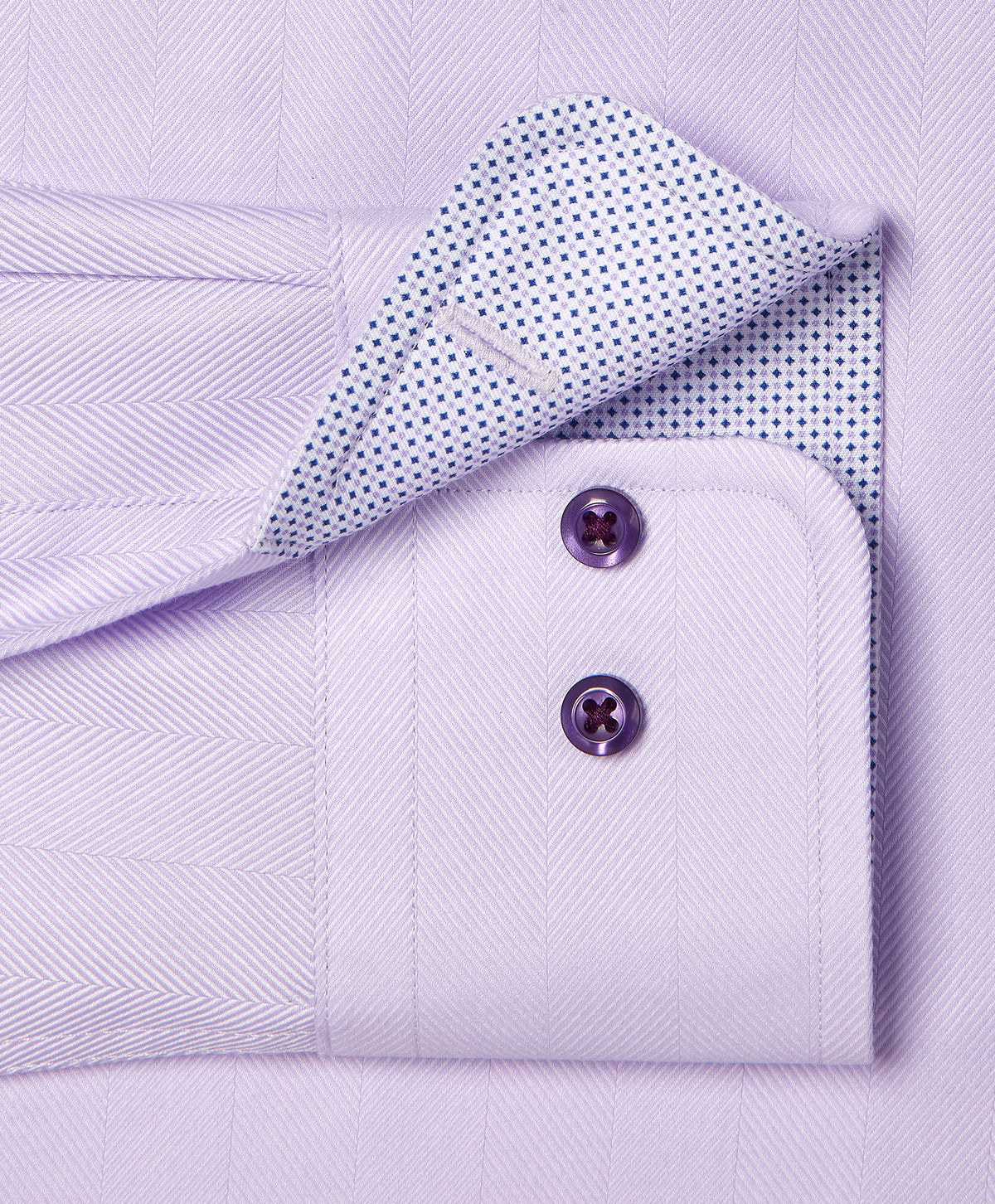 Close-up of the David Donahue Contrast Herringbone Solid Dress Shirt TBMS13100 cuff with two purple buttons and a white inner lining featuring small blue dots.
