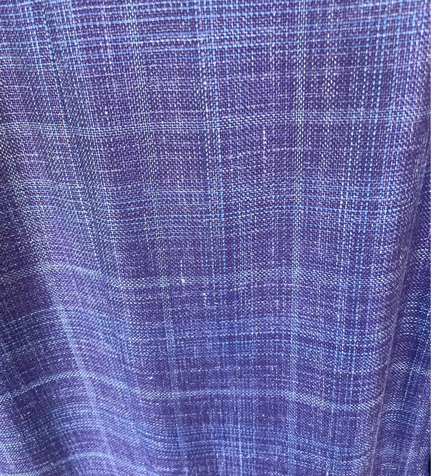 A close-up of a blue and purple woven fabric with a subtle plaid pattern, echoing the refined texture of the Byron Luca Soft Sport Coat 9547 by Byron.