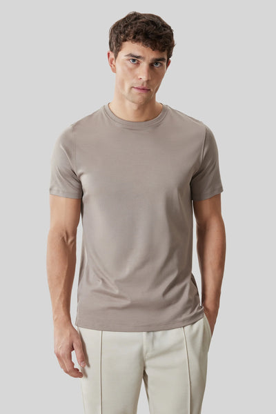 A man wearing a Robert Barakett Georgia Crew 23336 fitted taupe Pima cotton T-shirt and light beige pants stands against a plain light gray background.