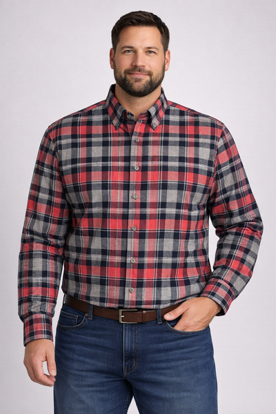 A man wearing the Batton Ballard Big & Tall Sport Shirt 7201-99 by Batton in red, gray, and navy plaid with blue jeans and a brown belt, standing against a plain background.
