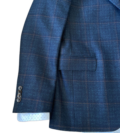 Close-up of the Jack Victor Sport Coat 1252209 in blue plaid Super 110’s Italian wool, with a flap pocket, four cuff buttons, and a white dotted shirt visible underneath. Brand: Jack Victor.