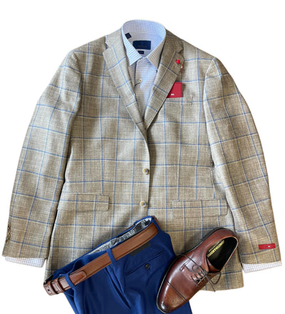 The TailoRed Gildo Sport Coat 88P0115, a beige plaid wool-silk-linen blend men's blazer, is styled over a light blue checkered shirt with blue trousers, a brown belt, and brown dress shoes.