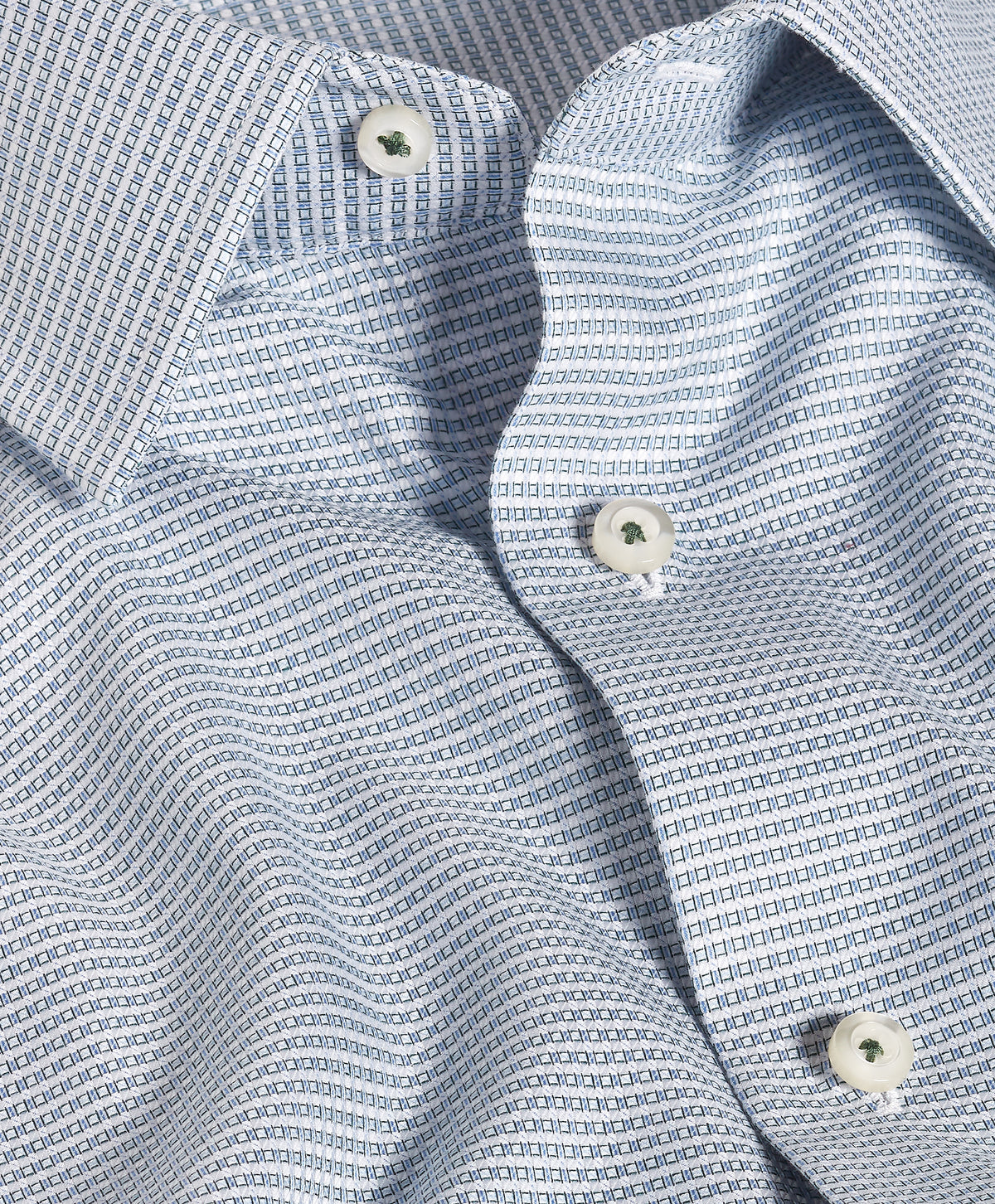 Close-up of a David Donahue Green & Sky Micro Dobby Dress Shirt TBSP13002, highlighting the micro dobby weave, white buttons, collar, and shirt front.