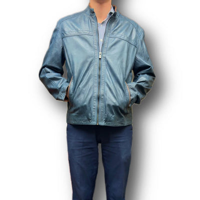 A person wearing the Missani Leather Jacket 392834 over a blue button-up shirt and blue trousers, standing with hands in the jacket pockets.