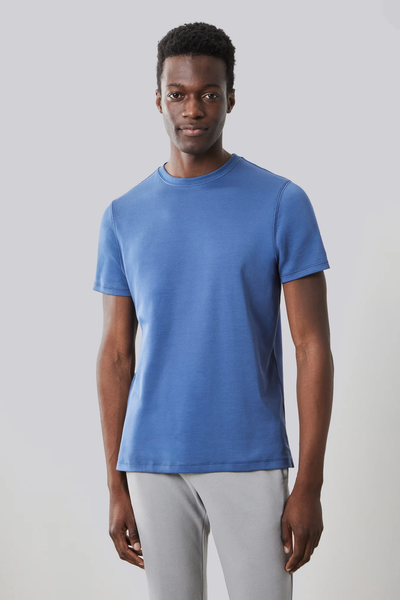 A man stands facing forward wearing a blue Robert Barakett Georgia Crew 23336 Tee Shirt and light gray pants, set against a plain light gray background.