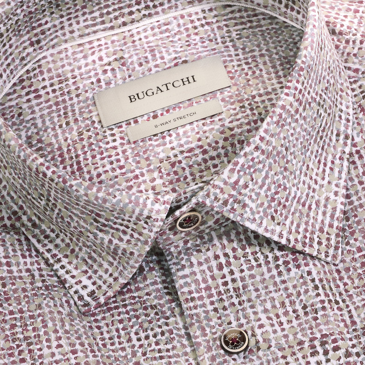 Close-up of the Bugatchi James Abstract Sport Shirt KF9300K60, showcasing its multicolored dotted geometric print along with the collar, label, and top buttons. This Bugatchi shirt is made from wrinkle-resistant cotton for effortless style and comfort.