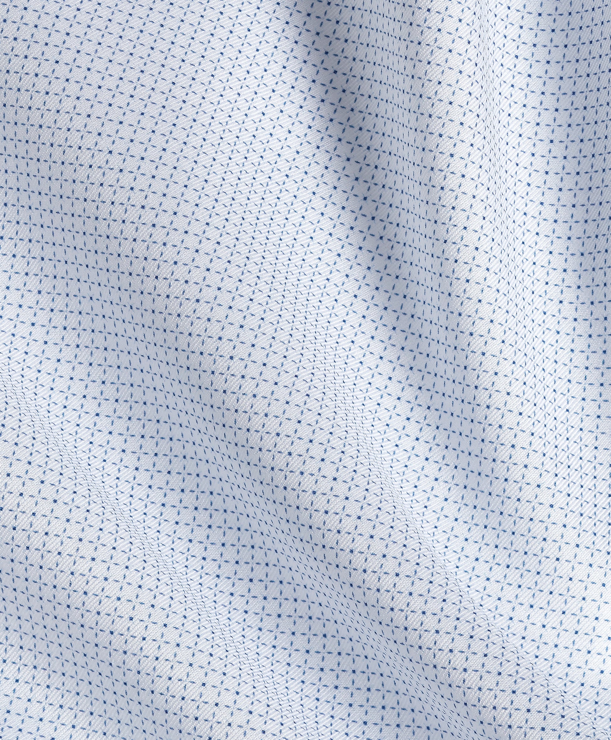 Close-up of the David Donahue Stretch Pima Dress Shirt (TBSP13005) by David Donahue, featuring soft white fabric with a repeating small blue dotted pattern, gentle folds, and a smooth texture characteristic of premium Pima cotton.
