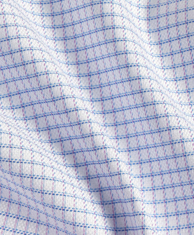 Close-up of a David Donahue OP Check Dress Shirt TBSP12821144, featuring white Pima cotton with blue and pink grid lines, highlighting its texture and gentle folds.