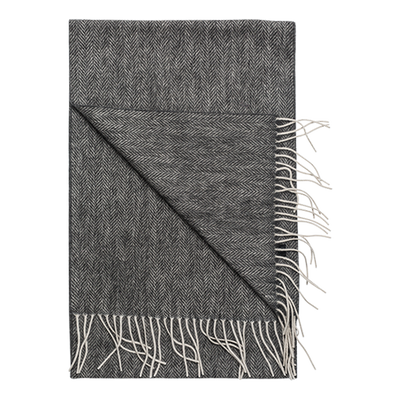 The Amanda Christensen Herringbone Scarf 44017 is a folded dark gray herringbone-patterned scarf with cream fringe, reminiscent of a wool throw and perfect as a sophisticated men's accessory, shown on a white background.