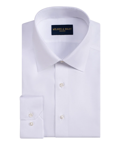A neatly folded WilkesRiley Queens Oxf Tailor white spread collar dress shirt with white buttons, made from Supima cotton, featuring a Wilkes & Riley label inside the collar.