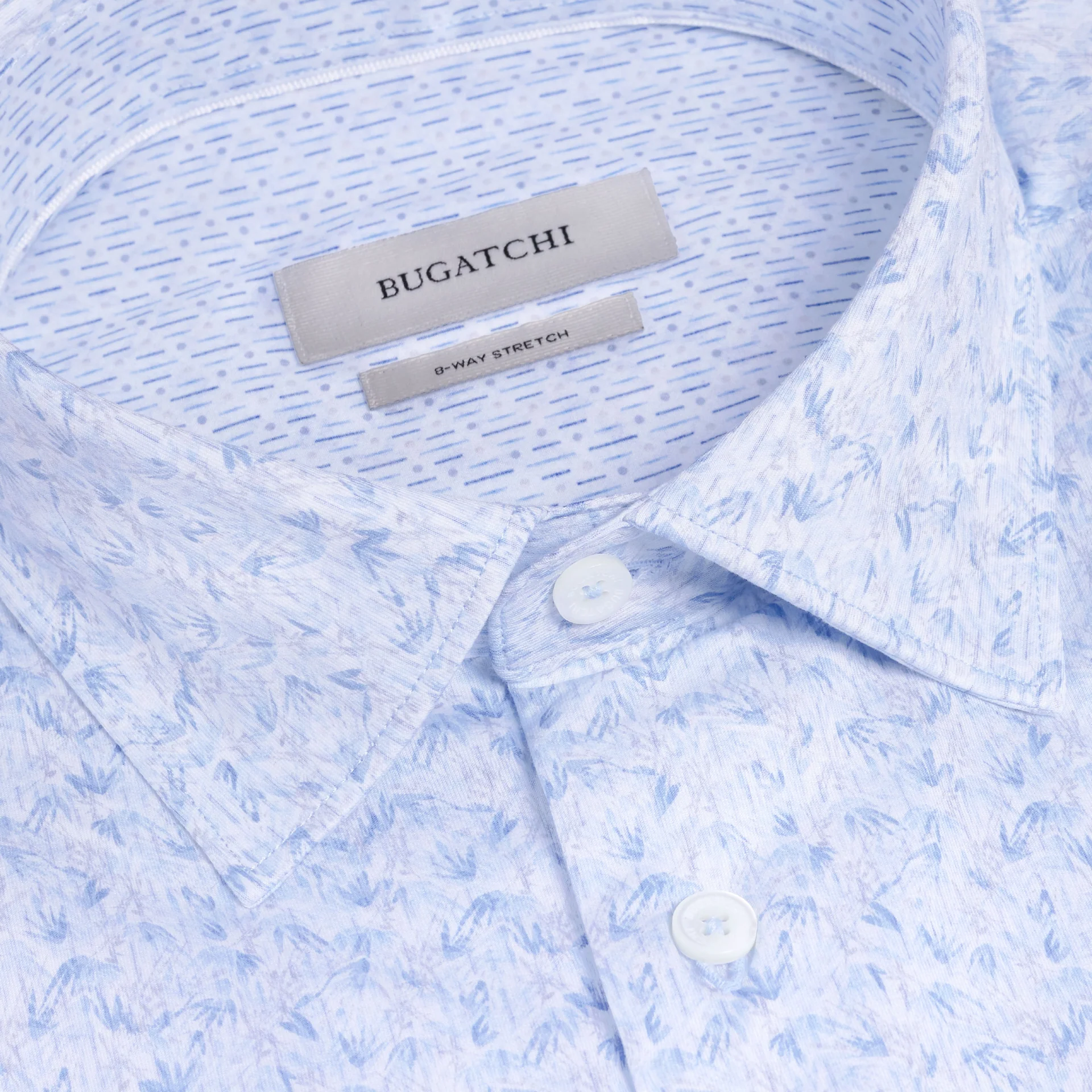Close-up of a light blue Bugatchi OP Jimmy OoohCotton® Shirt JF9648K61 featuring a subtle pattern, wrinkle-resistant performance fabric, white buttons, and a visible Bugatchi label inside the collar.