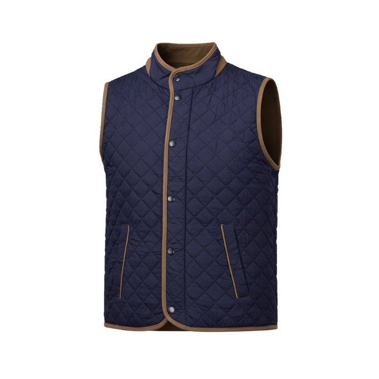 The F/X Fusion Upland Quilted Vest Big & Tall 13009 by F/X Fusion features a navy blue quilted design with brown trim, sleeveless construction, snap button closure, and two front pockets. Displayed on a plain white background, this lightweight men’s vest is ideal for easy layering and everyday comfort.
