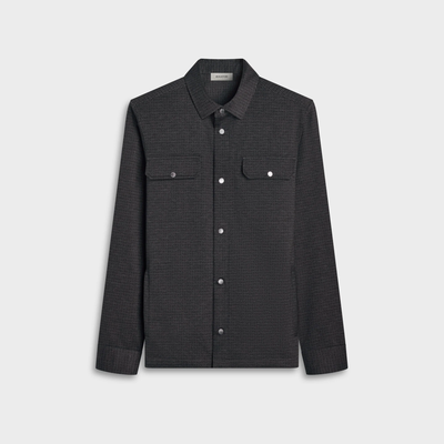 The Bugatchi Micro Check Knit Shirt KF2313K93 by Bugatchi is a dark grey long-sleeve shirt featuring performance stretch fabric, a button-up front, two chest pockets, a flat collar, and textured material, displayed on a plain light background.